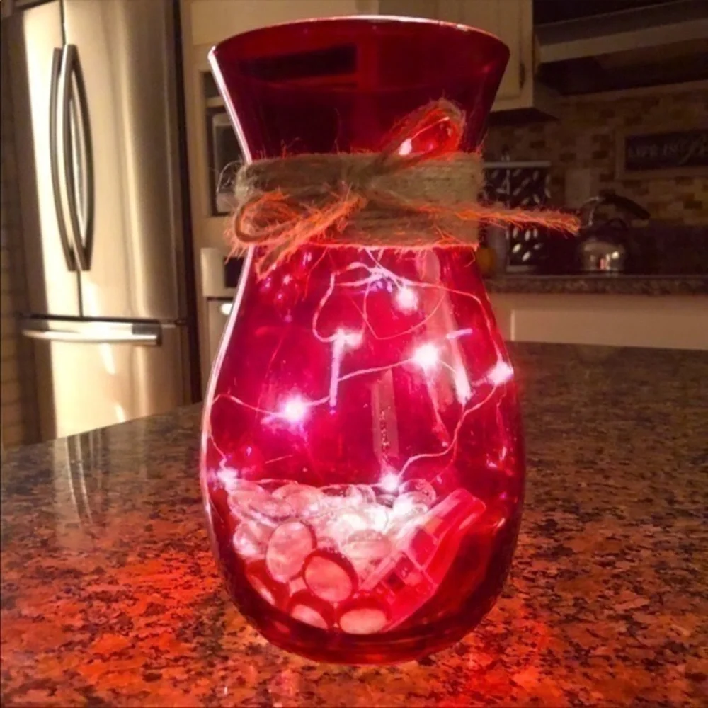 Red vase with string fairy lights